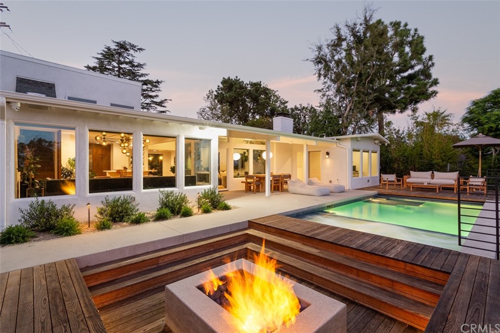 a view of swimming pool with a lounge chairs