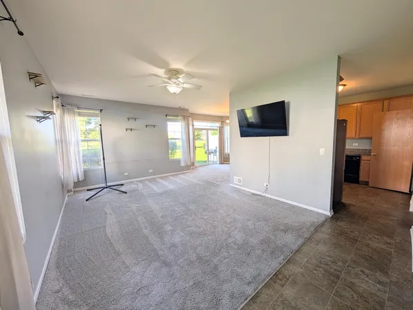 a view of a livingroom with an empty space and a window