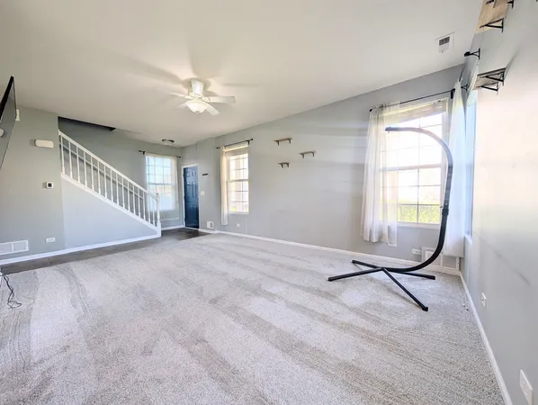 a view of a livingroom with a ceiling fan and window