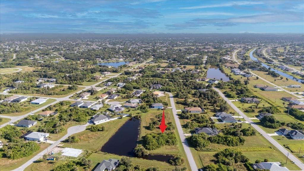 153 Spring Drive Rotonda West, FL 33947 - Photo 11 of 13 an aerial view of residential houses with outdoor space