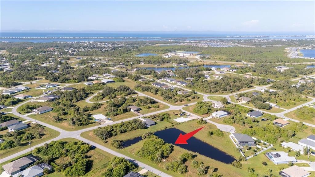 153 Spring Drive Rotonda West, FL 33947 - Photo 13 of 13 an aerial view of residential houses with outdoor space
