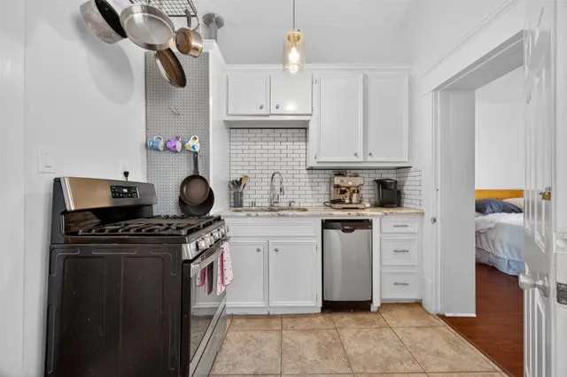 a kitchen with a stove and cabinets