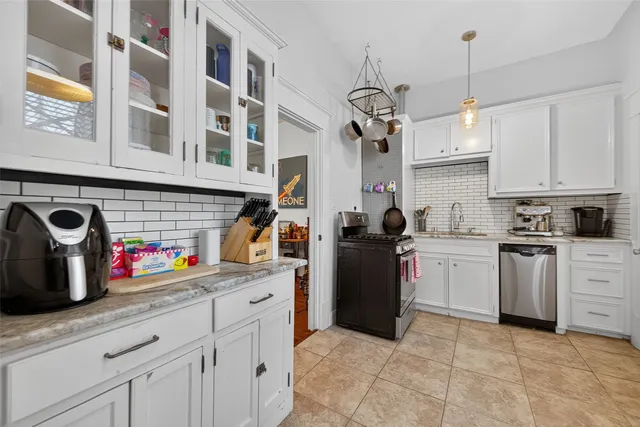 a kitchen with stainless steel appliances granite countertop a sink and cabinets