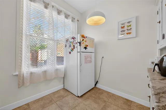 a view of kitchen with furniture and natural light
