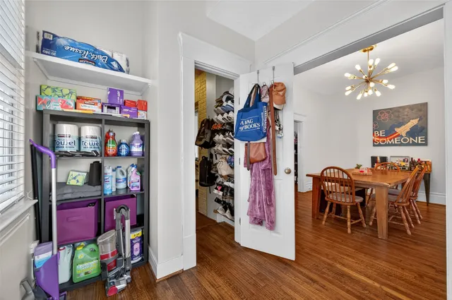 a view of a dining room with wooden floor and closet
