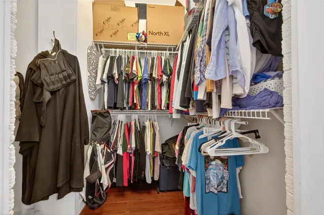 a view of walk in closet with clothes