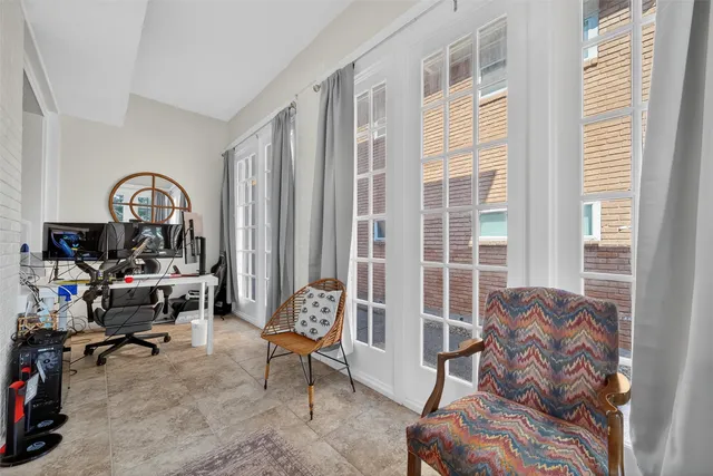 a living room with furniture and a floor to ceiling window