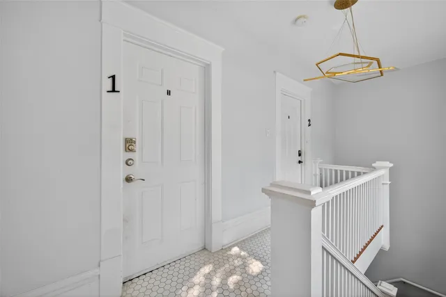 a view of a hallway with chandelier