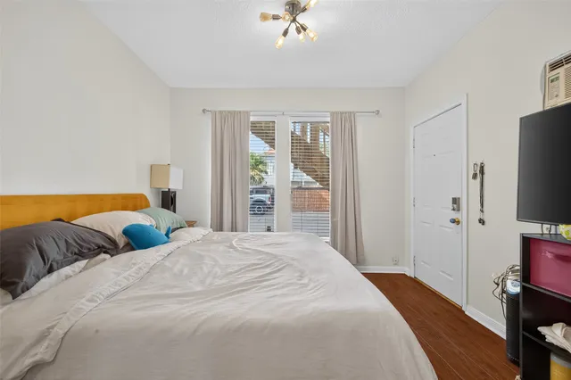 a bedroom with a bed and a flat tv screen