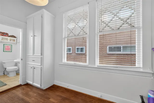 a view of a bathroom with a window and wooden floor