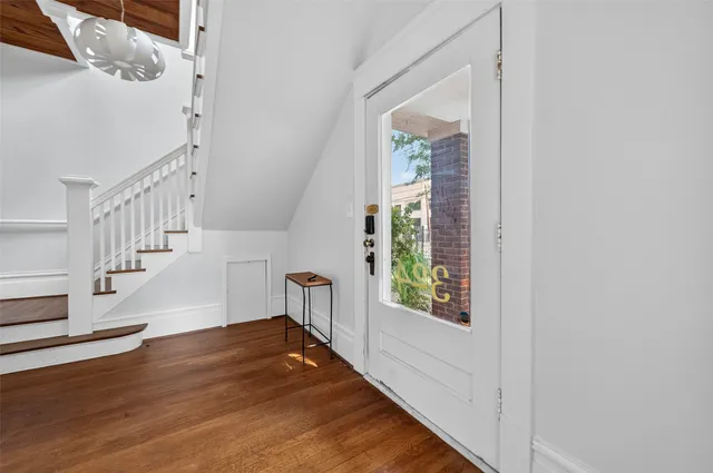 a view of entryway and hall with wooden floor