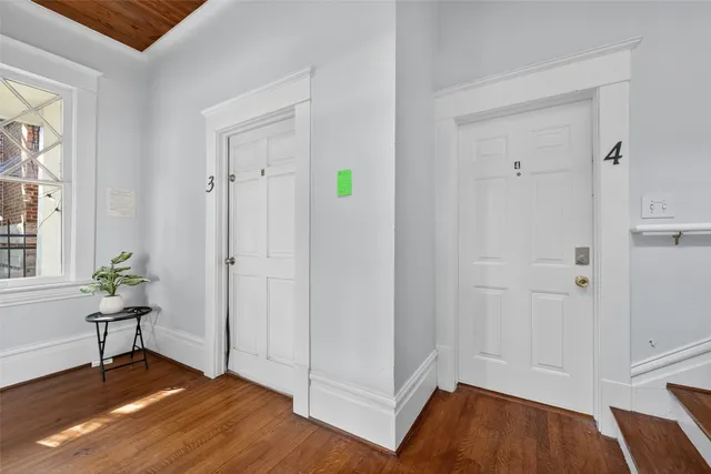 a view of an empty room and wooden floor