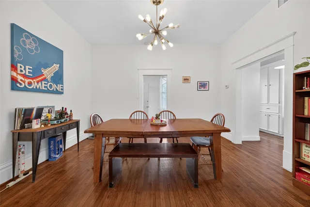 a view of a dining room with furniture wooden floor and a chandelier