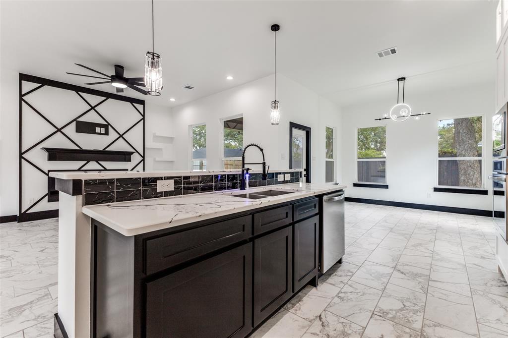 18508 Hickory Circle Kemp, TX 75143 - Photo 13 of 27 a kitchen with a sink a counter and chairs