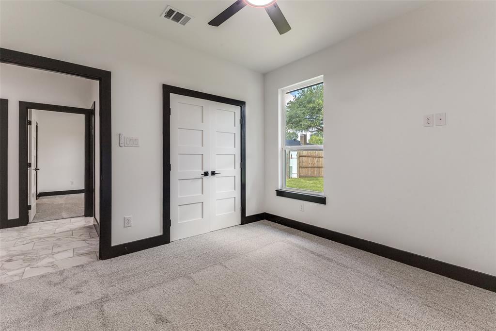 18508 Hickory Circle Kemp, TX 75143 - Photo 22 of 27 an empty room with chandelier fan and windows