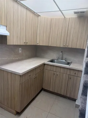 a kitchen with a sink and cabinets