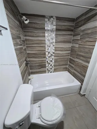 a bathroom with a toilet and a bathtub