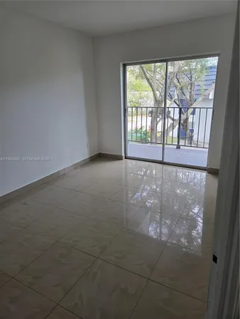 en empty room with windows and city view