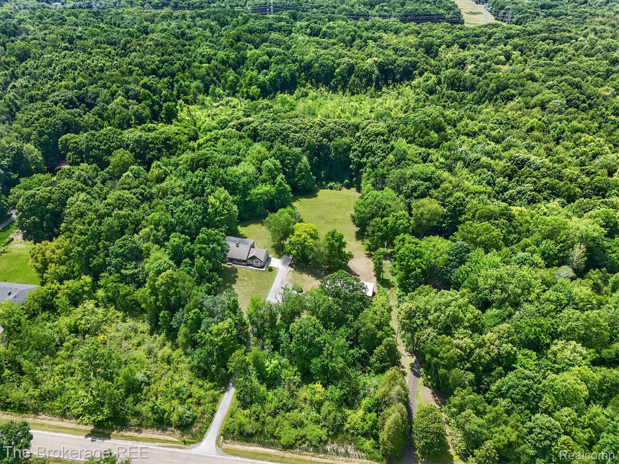 13269 North Genesee Road Clio, MI 48420 - Photo 62 of 67 Expansive wooded property featuring a single-story residence with a gabled roof