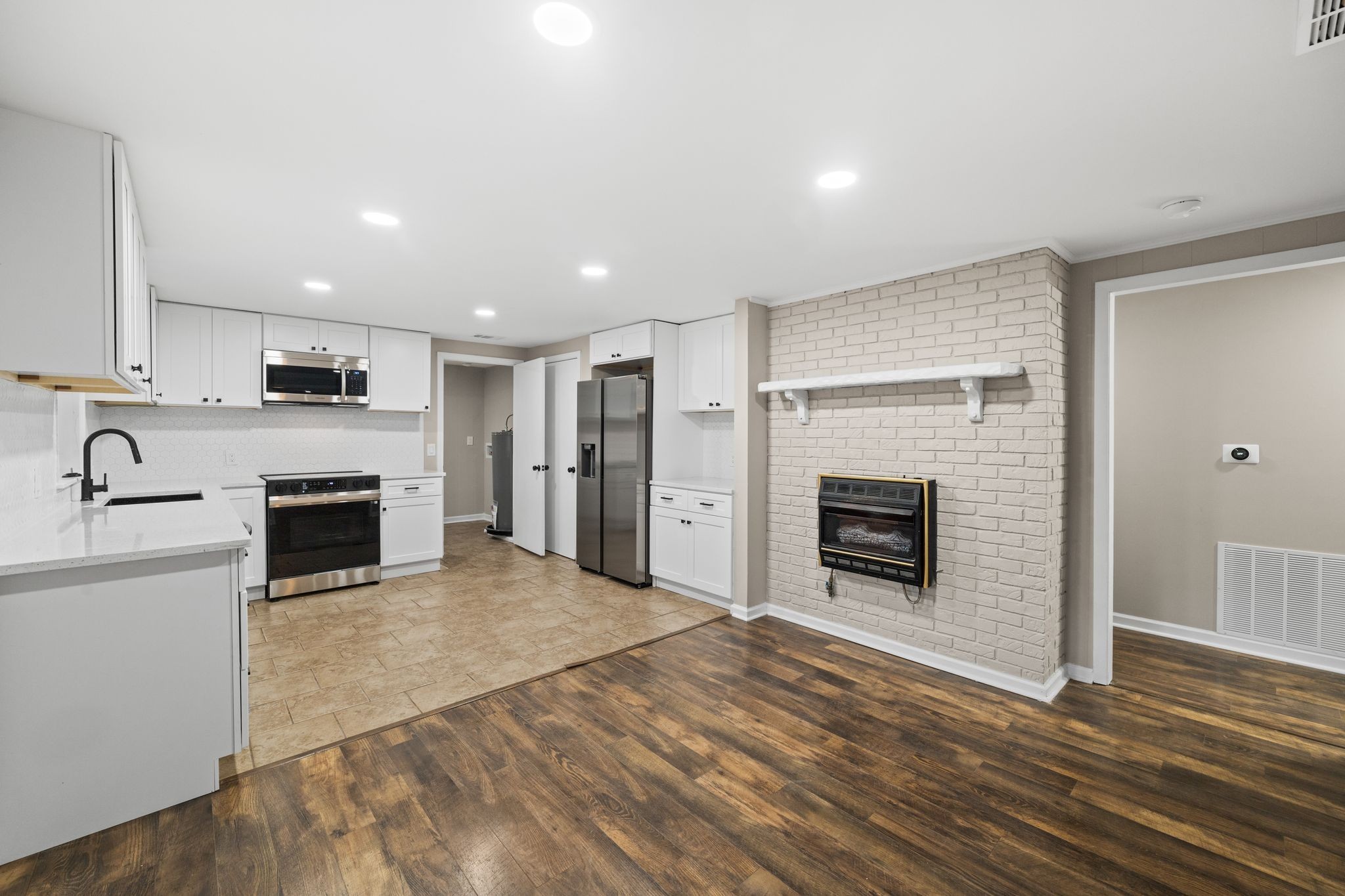 133 Mockerson Road Leoma, TN 38468 - Photo 16 of 33 a view of a kitchen with a sink a fireplace and a window