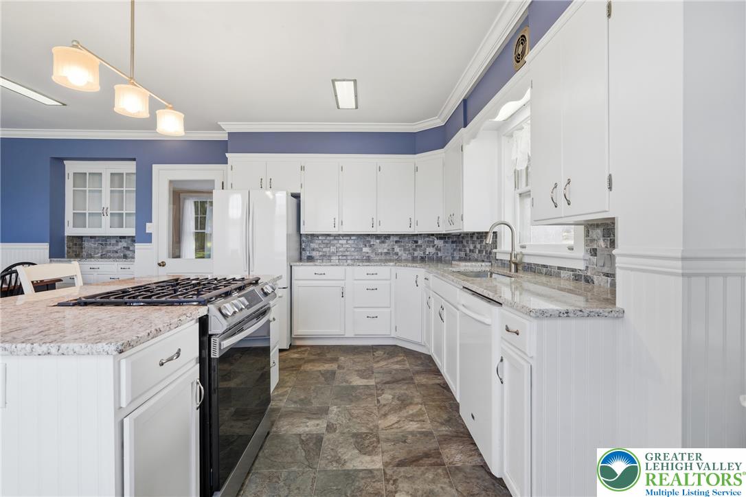 4682 Steuben Road Bethlehem, PA 18020 - Photo 17 of 79 White cabinetry with granite countertops and a sleek gas range define this inviting kitchen.