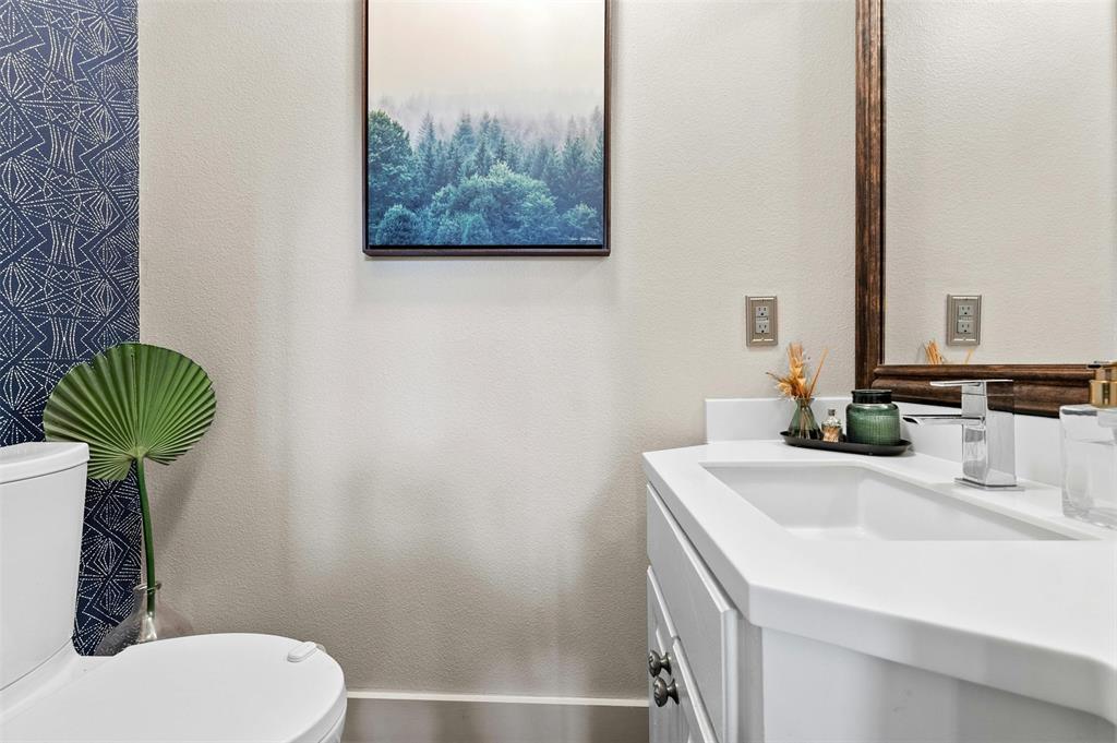 2802 Warren Street, Unit A Austin, TX 78703 - Photo 22 of 29 a bathroom with a sink a toilet and a mirror