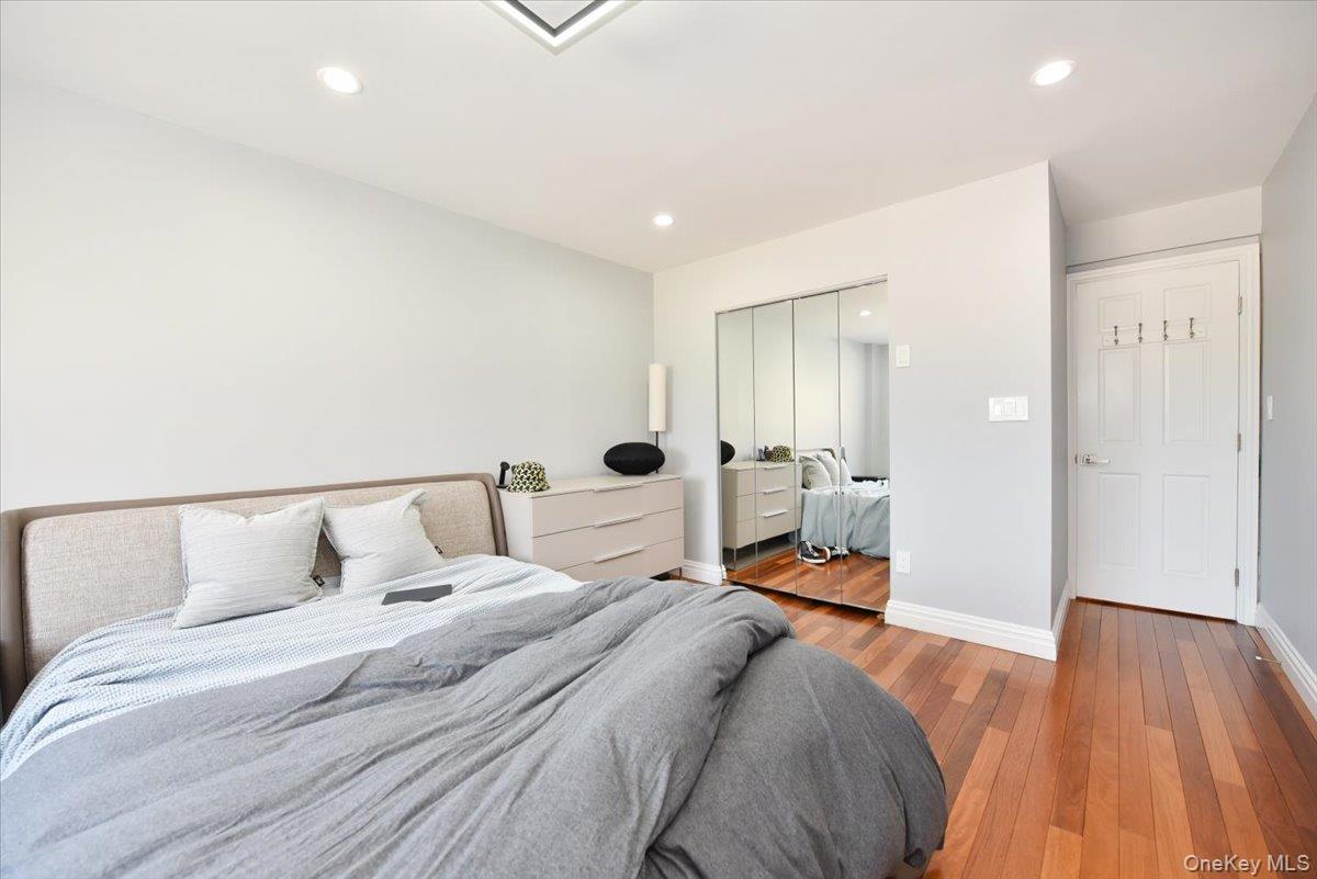 320 East Shore Road, Unit 2A Great Neck, NY 11023 - Photo 22 of 28 a bedroom with a bed and wooden floor