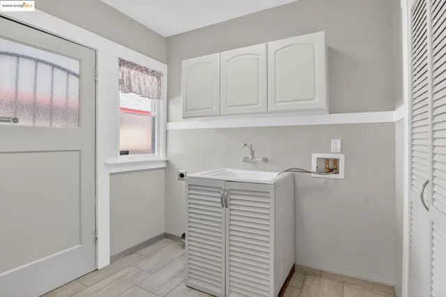 a utility room with cabinets washer and dryer