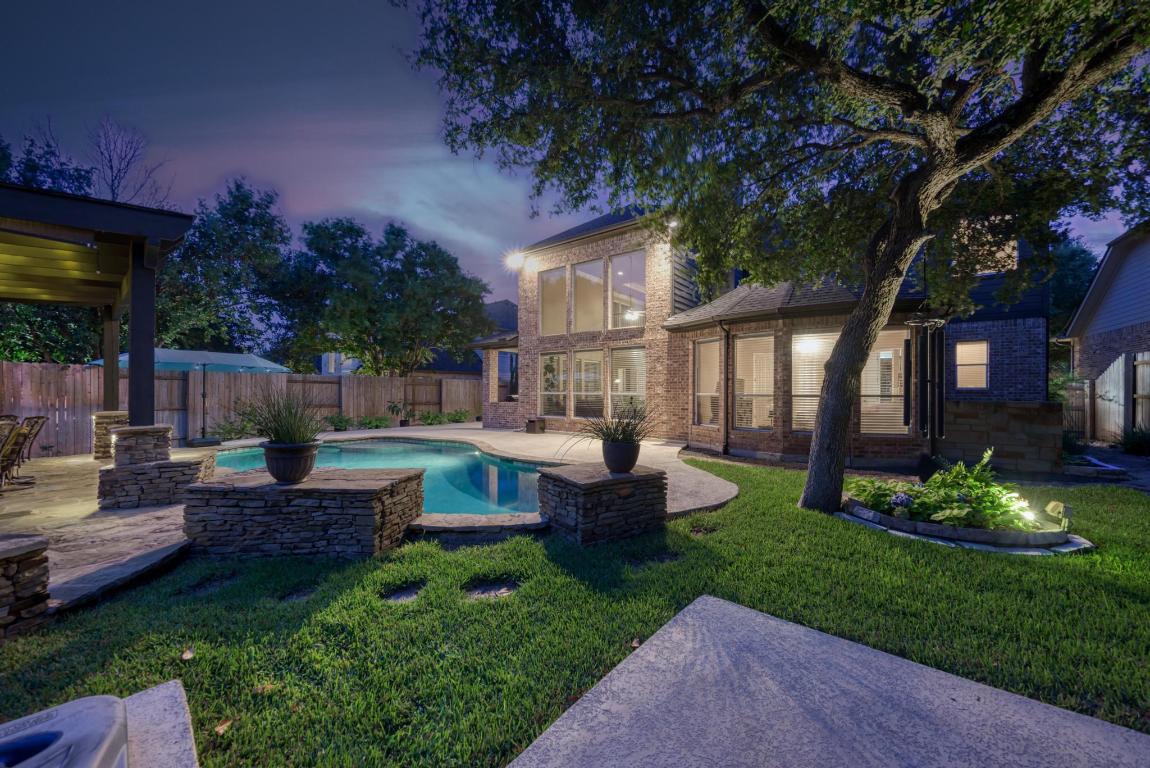 a front view of a house with garden and sitting area