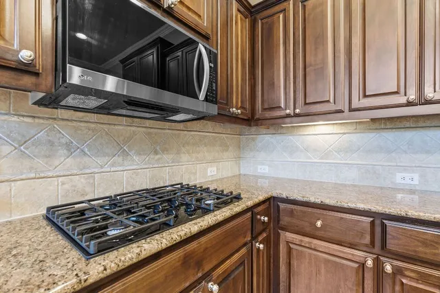 a kitchen with a sink stove and microwave