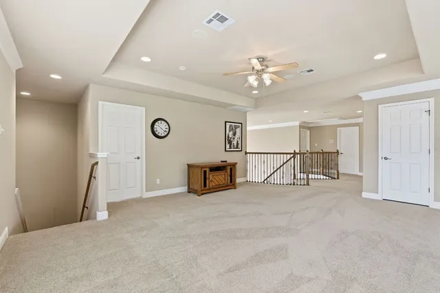 a view of a livingroom with a ceiling fan and window