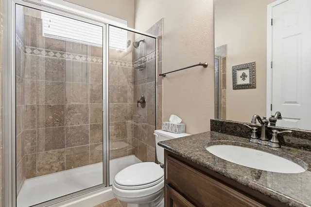 a view of a backyard with swimming pool and furniture