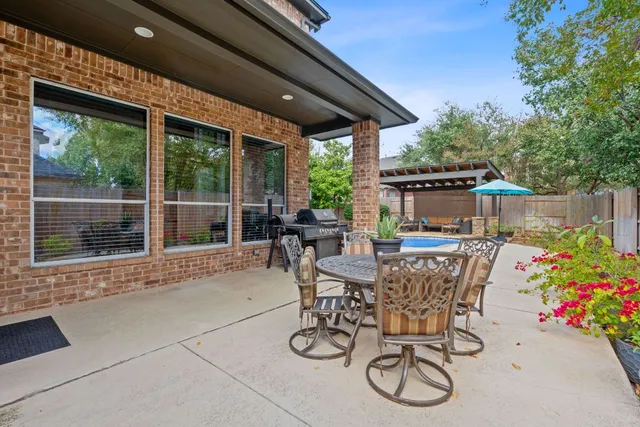 a view of a patio with couches table and chairs and potted plants