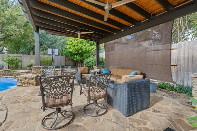 a view of a house with a big yard and large trees