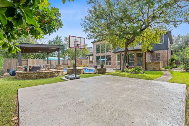 a front view of a house with garden and sitting area