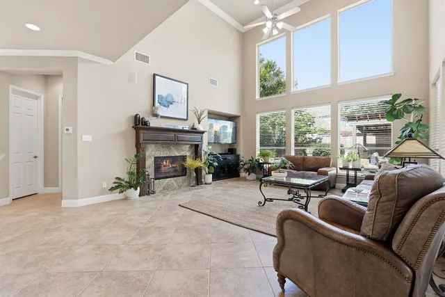 a living room with furniture a large window and a fireplace