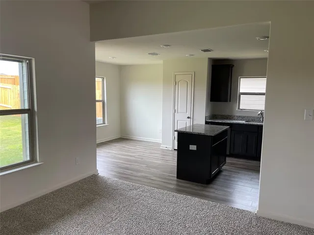 a view of a kitchen counter top space with wooden floor