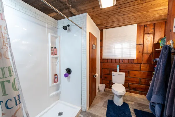 a bathroom with a toilet and a shower