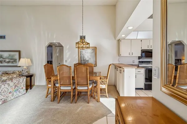 a view of a livingroom with furniture and a mirror
