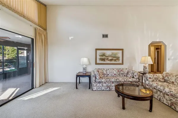 a bedroom with furniture and a large window