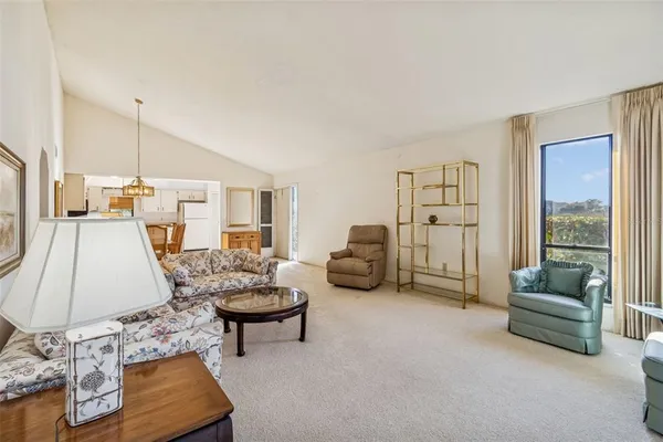 a kitchen with a sink a refrigerator and white cabinets