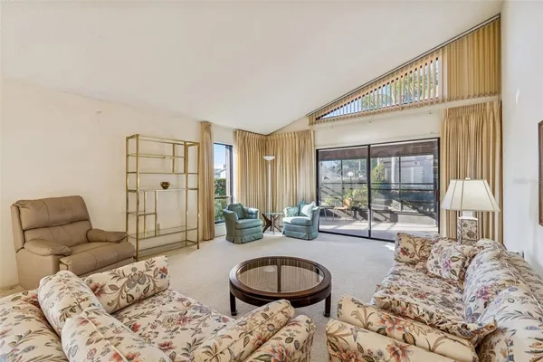 a kitchen with white cabinets a refrigerator and a sink