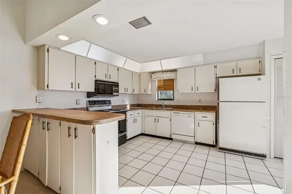 a kitchen with a refrigerator a stove a washer and dryer