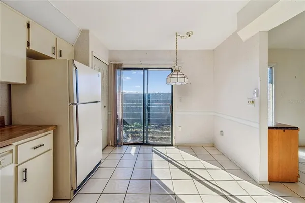 a spacious bedroom with a bed and a chandelier