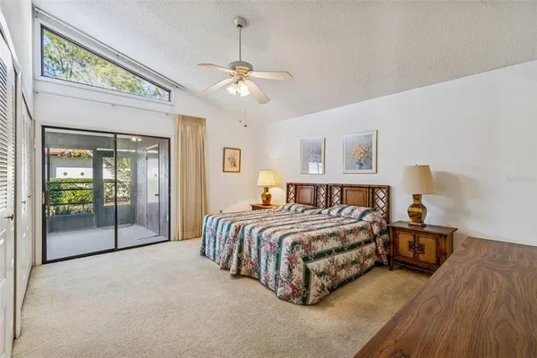 a bedroom with a large bed and a chandelier