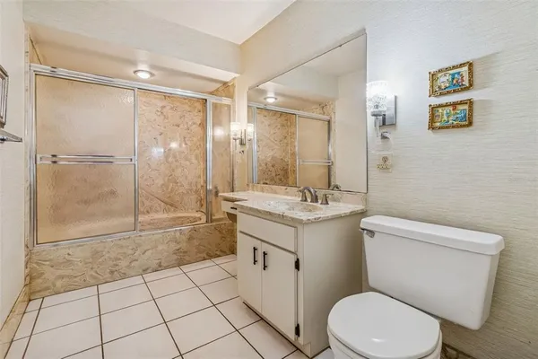 a view of a hallway with wooden floor and closet