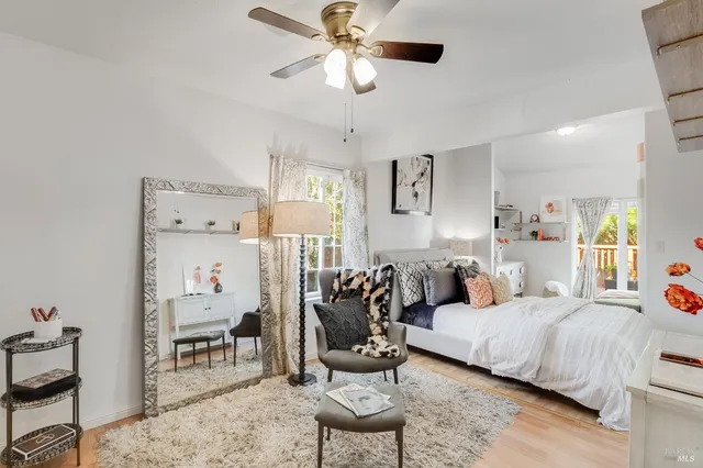 a bedroom with a bed and wooden floor
