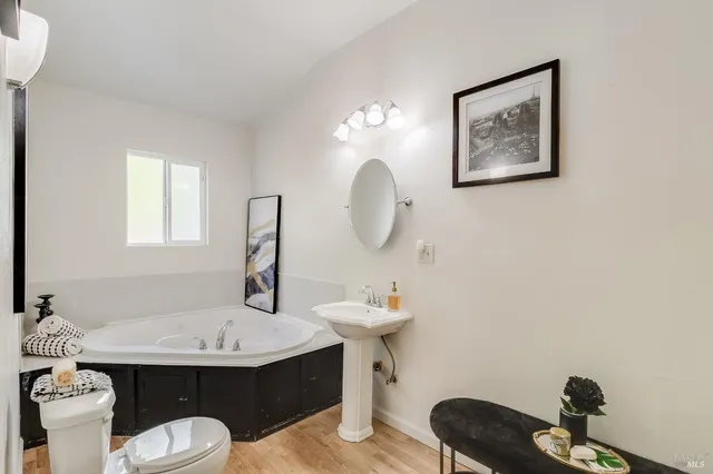 a bathroom with a sink a toilet and shower curtain