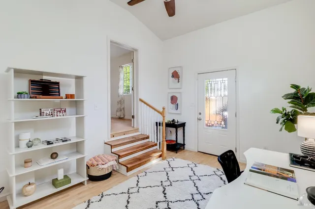 a living room with furniture and a potted plant
