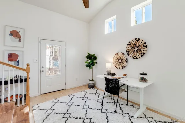 a view of a livingroom with furniture and entryway